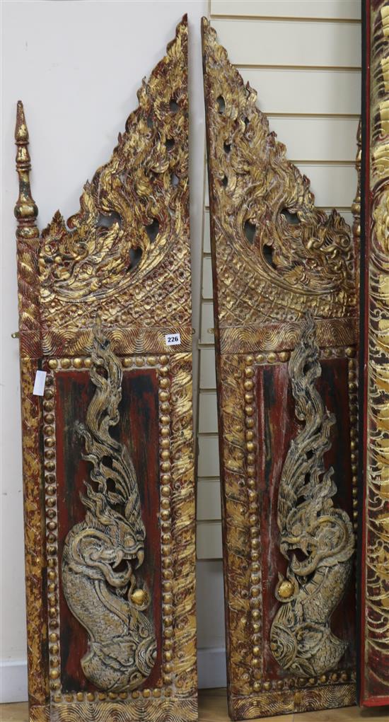 A pair of Thai polychrome and gilt dragon panels each panel width 36cm height 52cm